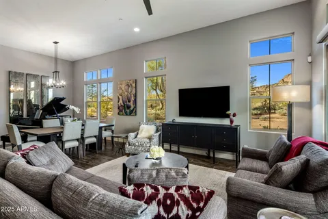 a living room filled with furniture and a flat screen tv