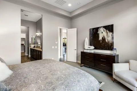 a spacious bedroom with a bed and a large window