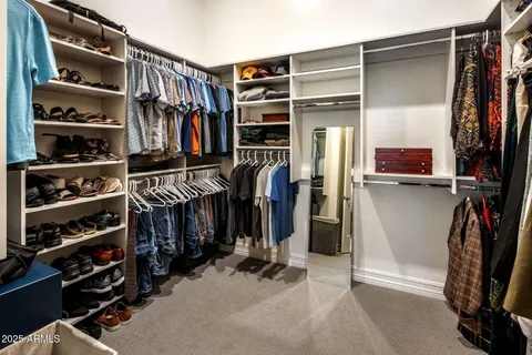 a en suite bathroom with a double vanity sink and a large mirror