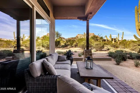 a balcony with furniture and a potted plant