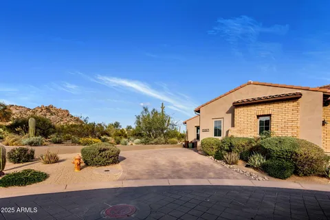a view of a house with large windows and couches