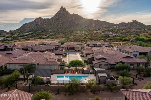 an aerial view of residential houses with outdoor space