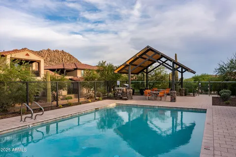 an aerial view of a house with swimming pool patio and fire pit