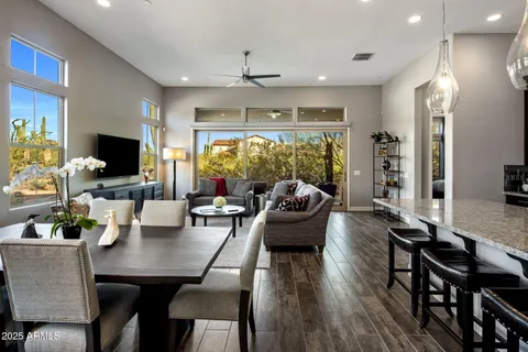 a living room with furniture a flat screen tv and a large window