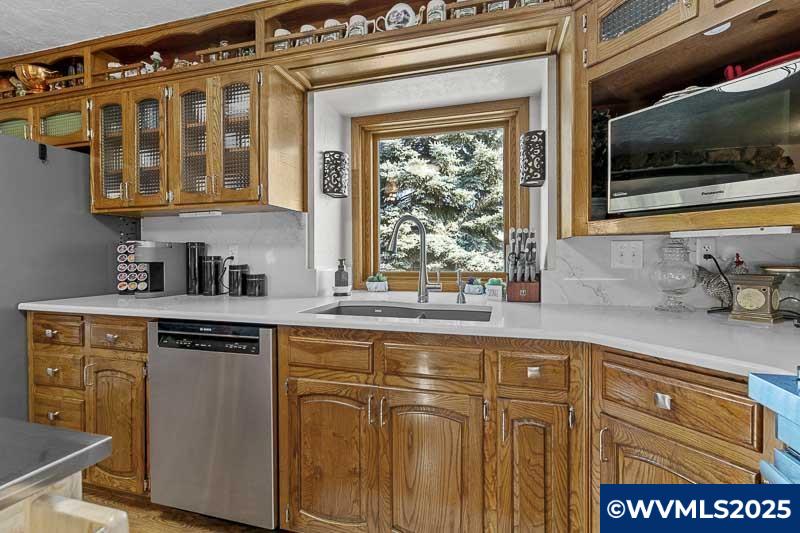 11660 Simpson Road Monmouth, OR 97361 - Photo 14 of 50 a kitchen with stainless steel appliances granite countertop a sink and a microwave