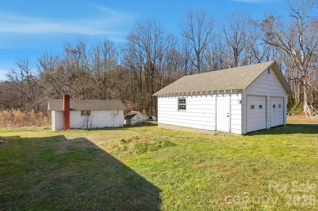 a view of a house with backyard and wooden fence