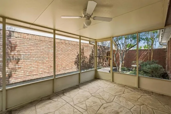 a view of a room with window and a ceiling fan