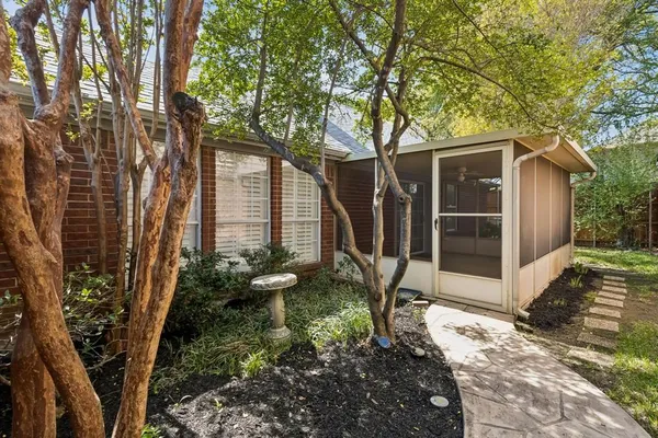 a front view of a house with a tree
