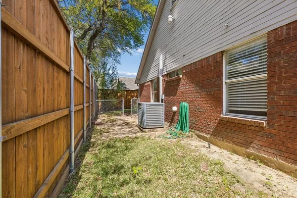 a view of a house with wooden fence