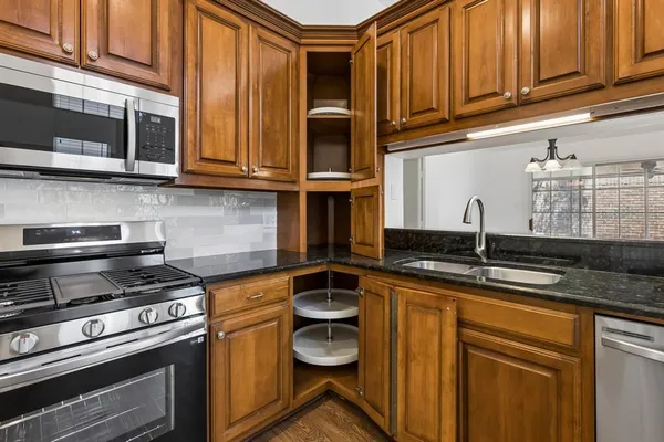 a kitchen with stainless steel appliances granite countertop a stove and a sink