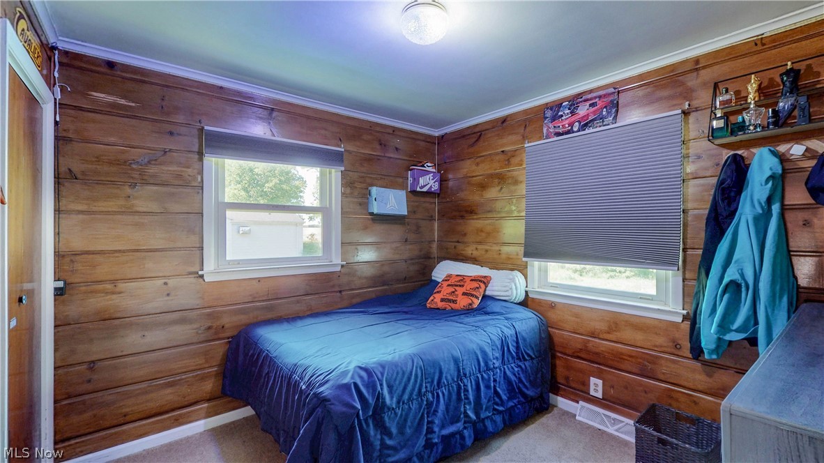 3659 Morrow Road Kent, OH 44240 - Photo 21 of 39 Wood paneling throughout, featuring white trim and two windows