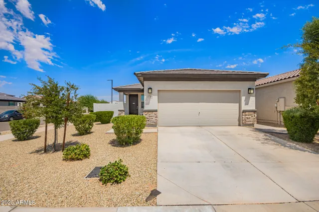 a front view of a house with potted plants