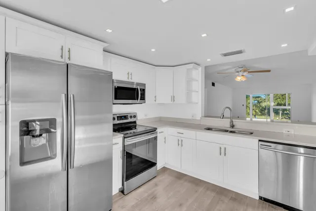 a kitchen with granite countertop stainless steel appliances and sink