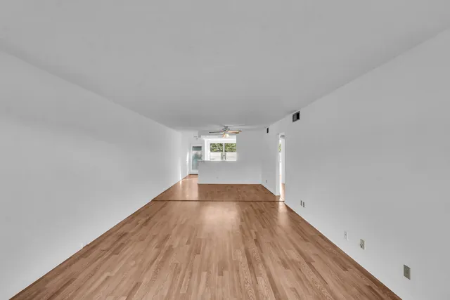 a view of an empty room and wooden floor