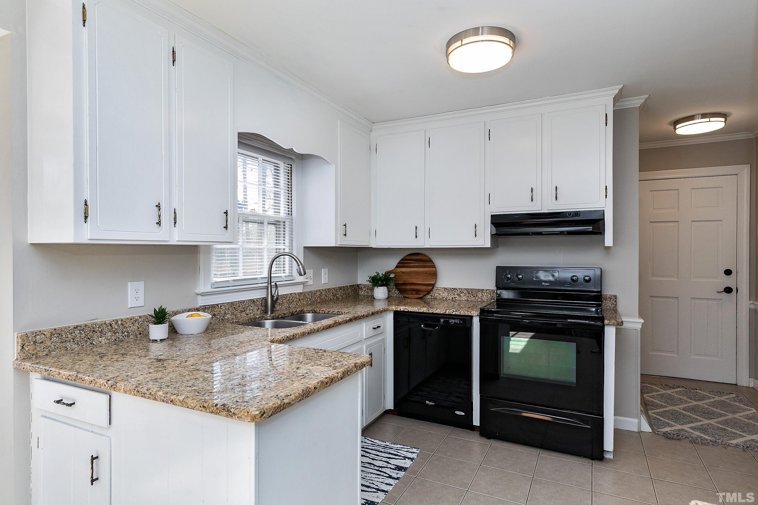 2012 Port Royal Road Raleigh, NC 27609 - Photo 14 of 36 a kitchen with granite countertop a stove sink and cabinets