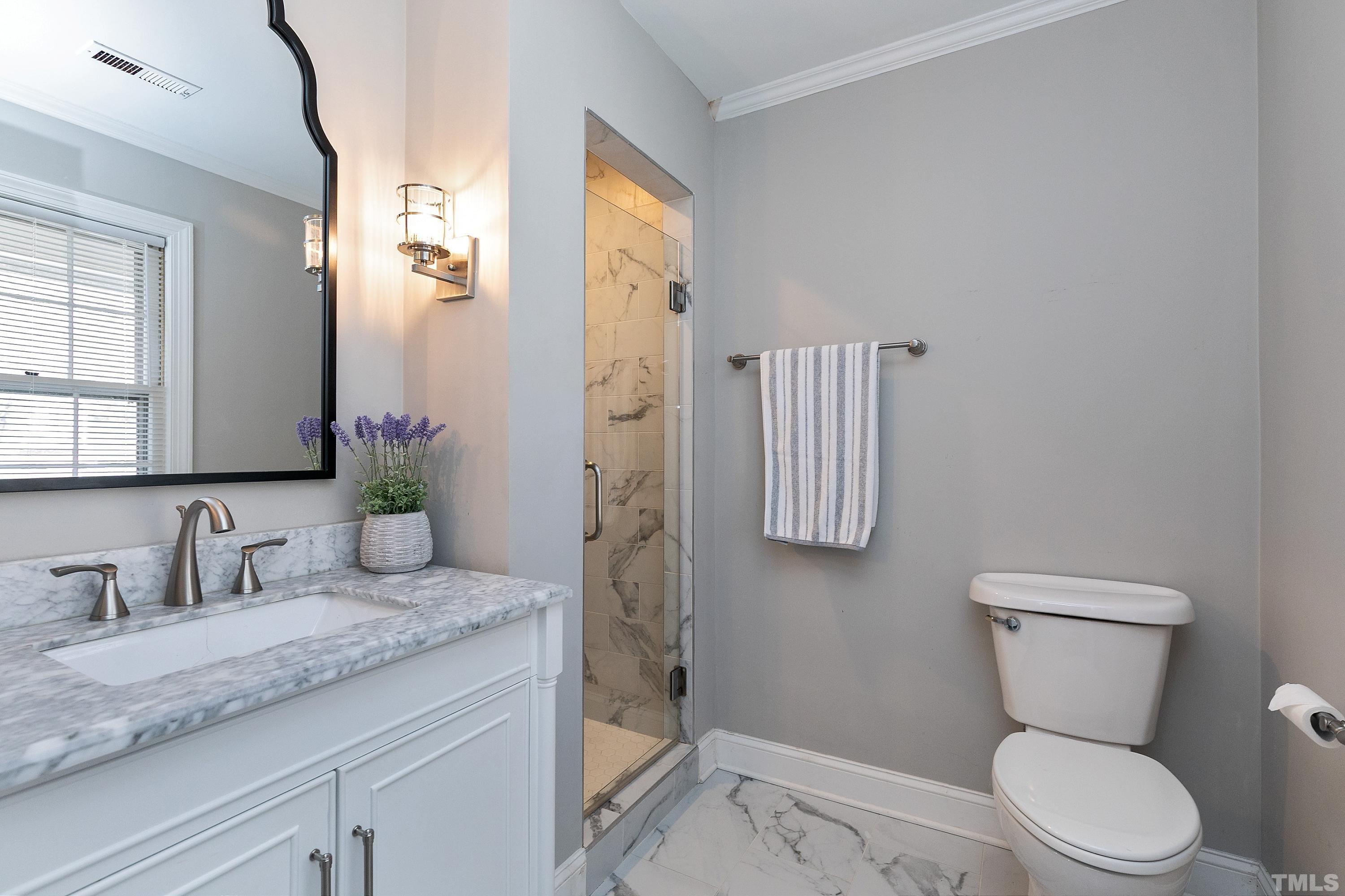 2012 Port Royal Road Raleigh, NC 27609 - Photo 21 of 36 a bathroom with a granite countertop toilet sink and mirror
