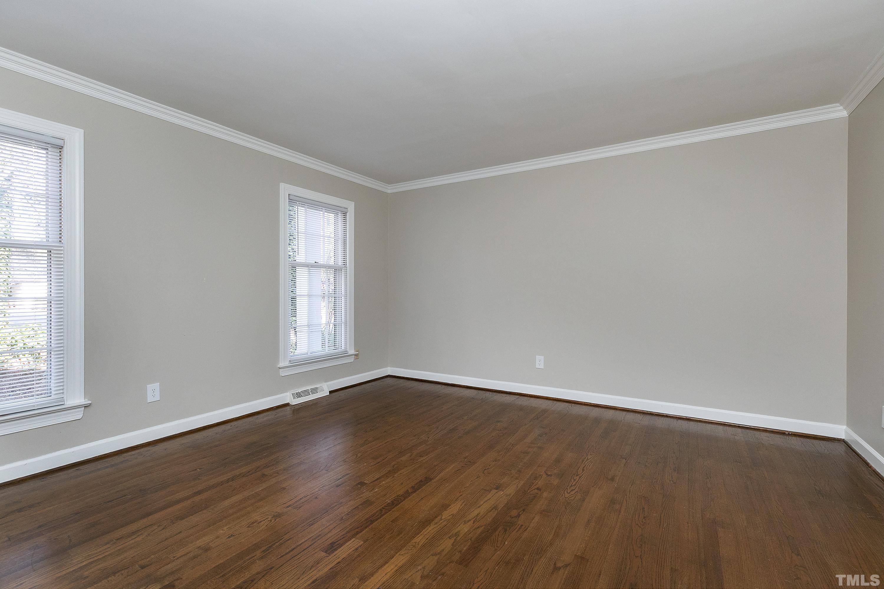 2012 Port Royal Road Raleigh, NC 27609 - Photo 6 of 36 an empty room with wooden floor and windows