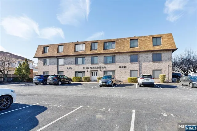 a view of a cars park in front of a building