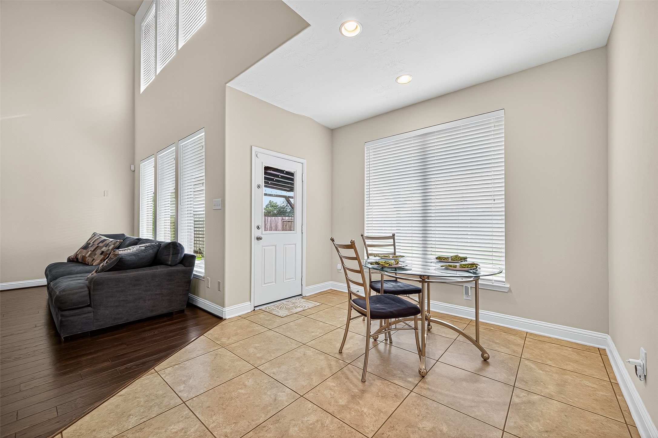 8107 Lockridge Terrace Lane Cypress, TX 77433 - Photo 13 of 50 This cozy breakfast nook, just off the grand living area, offers the perfect space to start your day with sunshine and serenity. Surrounded by windows, natural light pours in, highlighting the elegant tile flooring and airy ceiling height. It's an intimate space with a grand ambiance—ideal for casual dining or morning coffee with a view.