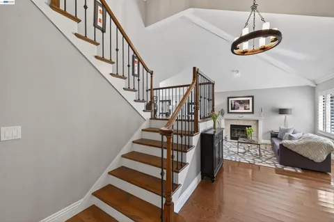 a view of entryway livingroom and hall with wooden floor