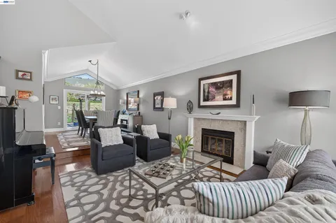 a living room with furniture fireplace and window