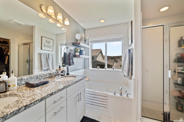 1836 Red Oak Road Eagle Mountain, UT 84005 - Photo 14 of 15 Full bath featuring a shower stall, a garden tub, double vanity, a spacious closet, and recessed lighting