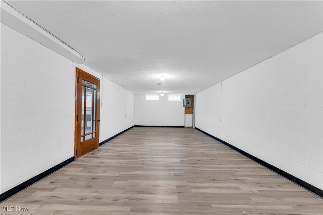 19720 Upper Terrace Road Euclid, OH 44117 - Photo 27 of 31 Empty room featuring a textured ceiling and light wood-type flooring