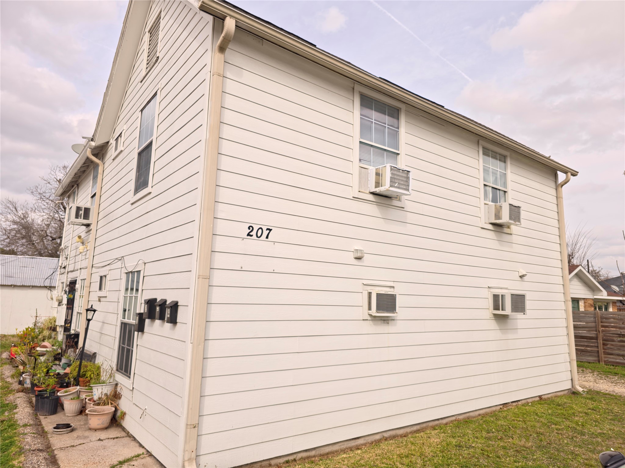 a view of a white house with a white roof deck