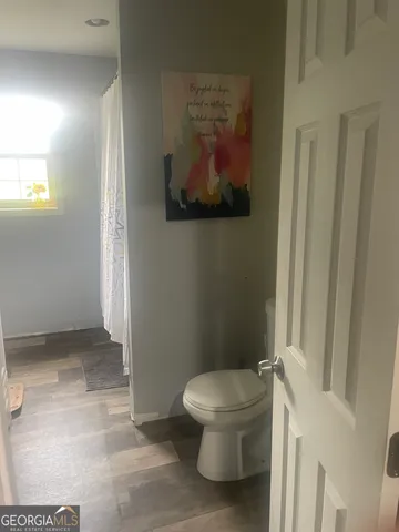 a white toilet sitting next to a shower curtain
