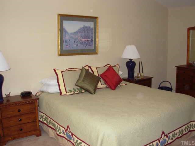 238 Royal Tower Way Cary, NC 27513 - Photo 7 of 12 a bedroom with a bed and a lamp on dresser