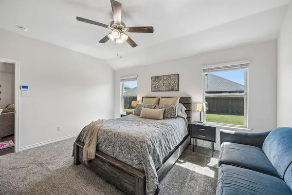 a bedroom with a bed couch and window
