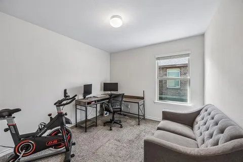 a livingroom with workspace and a couch