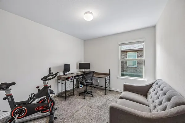 a livingroom with workspace and a couch