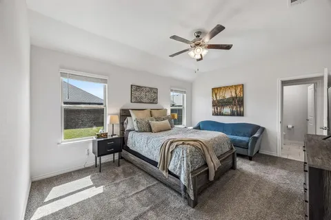 a spacious bedroom with a bed and a window