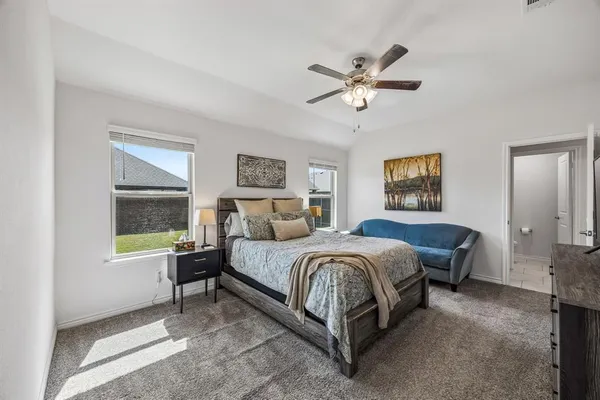 a spacious bedroom with a bed and a window