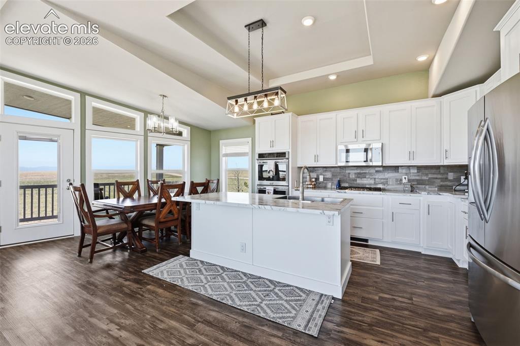 23335 Sanborn Road Calhan, CO 80808 - Photo 7 of 28 Open concept living, dining, and kitchen layout ideal for gathering