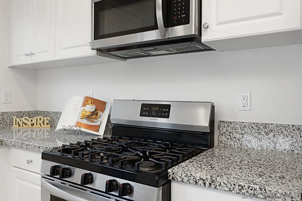 258 Windsor Grey Way Fallbrook, CA 92028 - Photo 15 of 44 a kitchen with a stove and a microwave