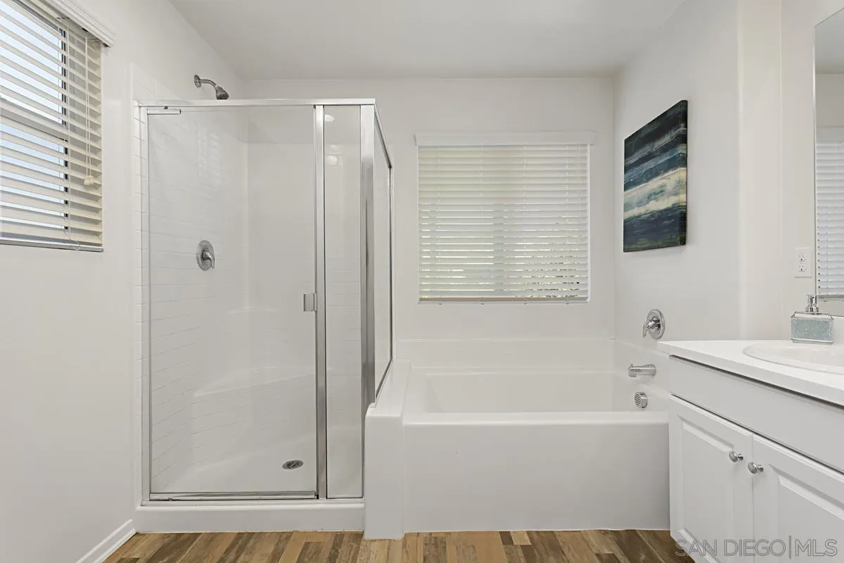 258 Windsor Grey Way Fallbrook, CA 92028 - Photo 28 of 44 a bathroom with a bathtub a shower a sink and a mirror