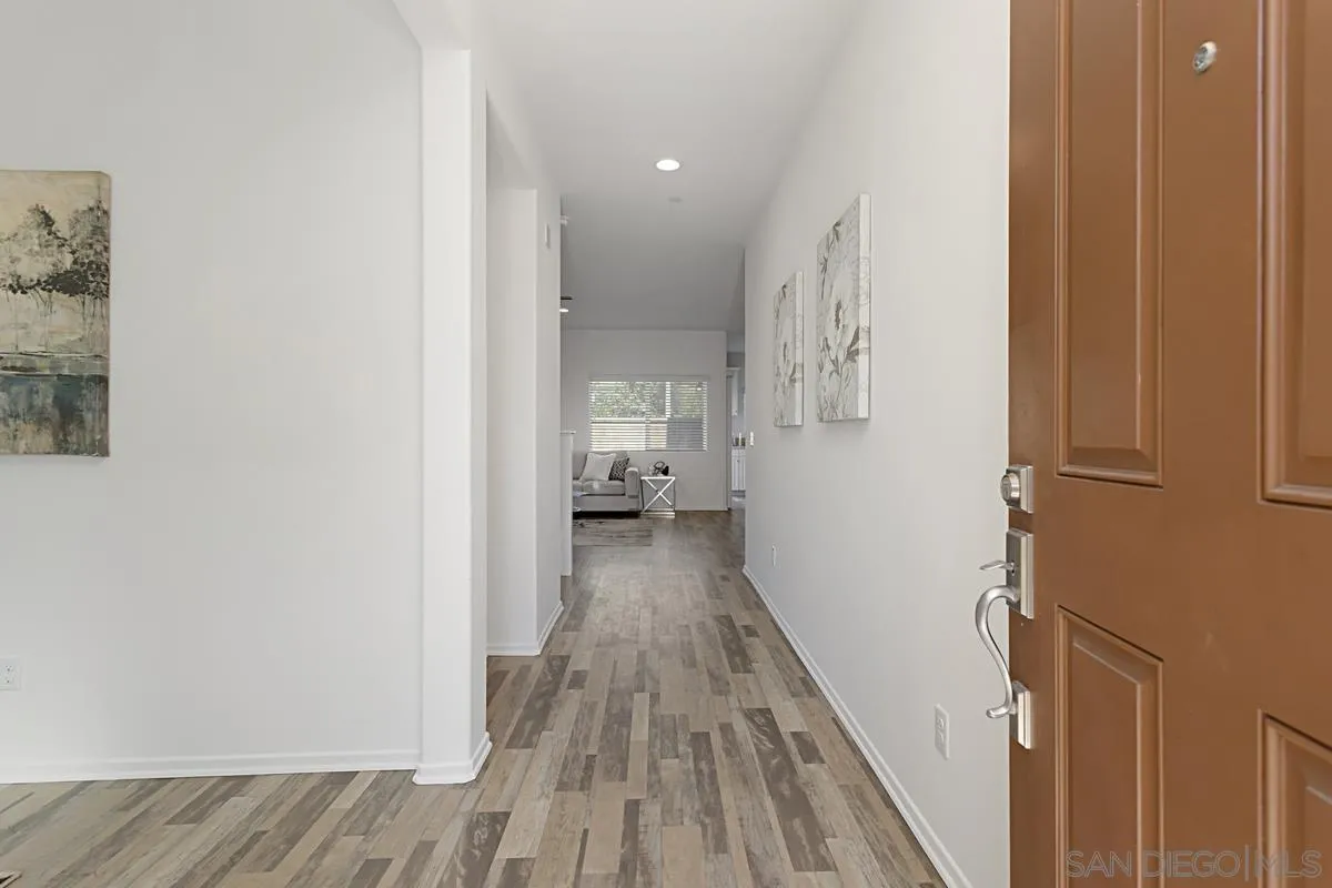 258 Windsor Grey Way Fallbrook, CA 92028 - Photo 3 of 44 a view of a hallway with wooden floor and staircase