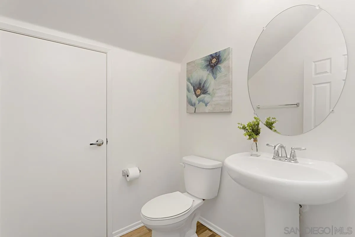 258 Windsor Grey Way Fallbrook, CA 92028 - Photo 5 of 44 a white toilet sitting next to a bathroom sink