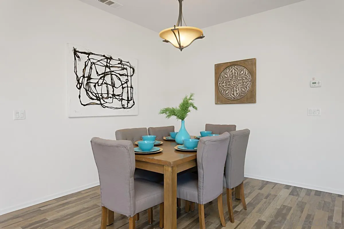 258 Windsor Grey Way Fallbrook, CA 92028 - Photo 10 of 44 a view of a dining room with furniture and wooden floor
