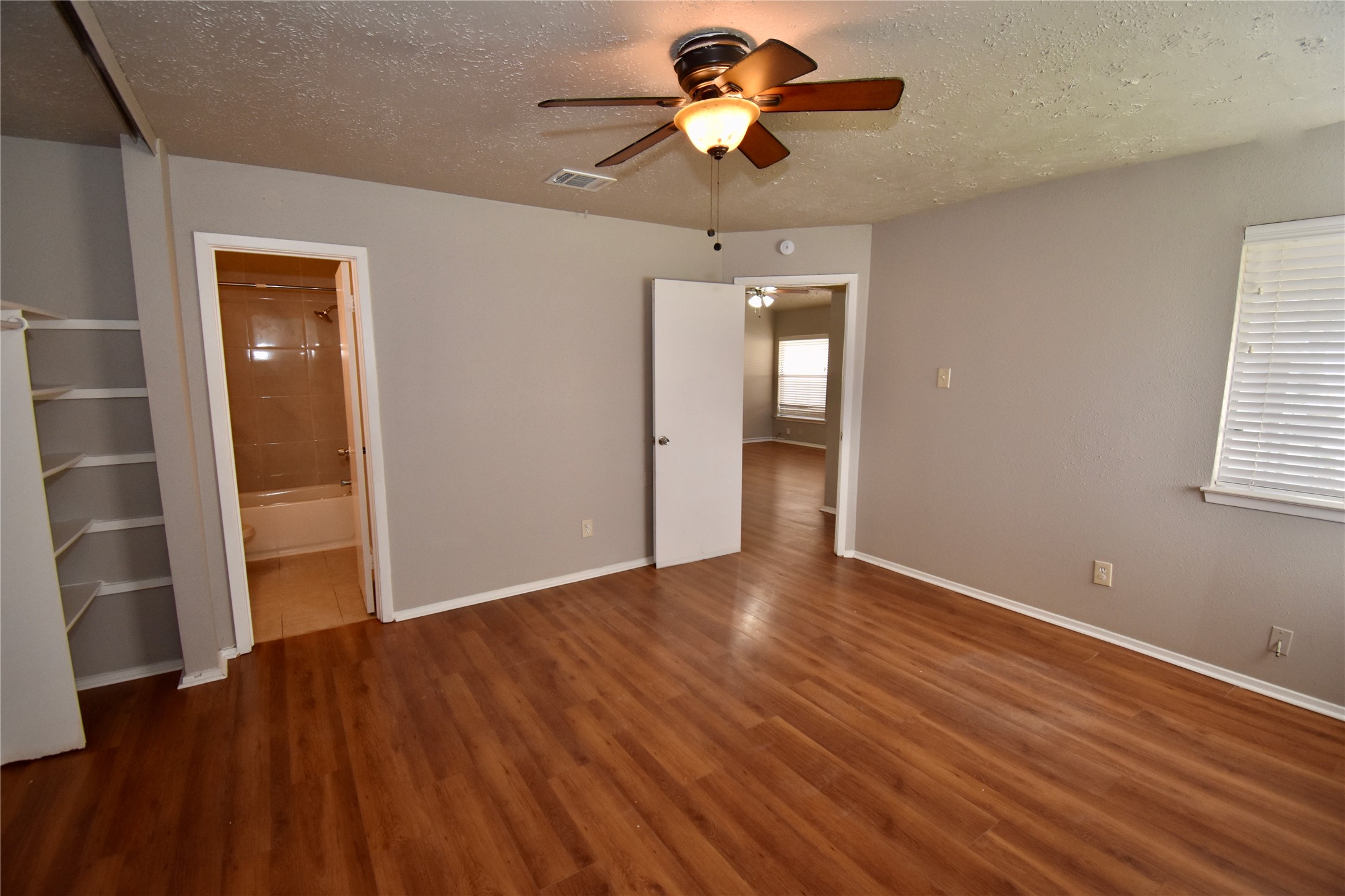 9231 Goodmeadow Drive Houston, TX 77064 - Photo 16 of 26 wooden floor in an empty room with a window