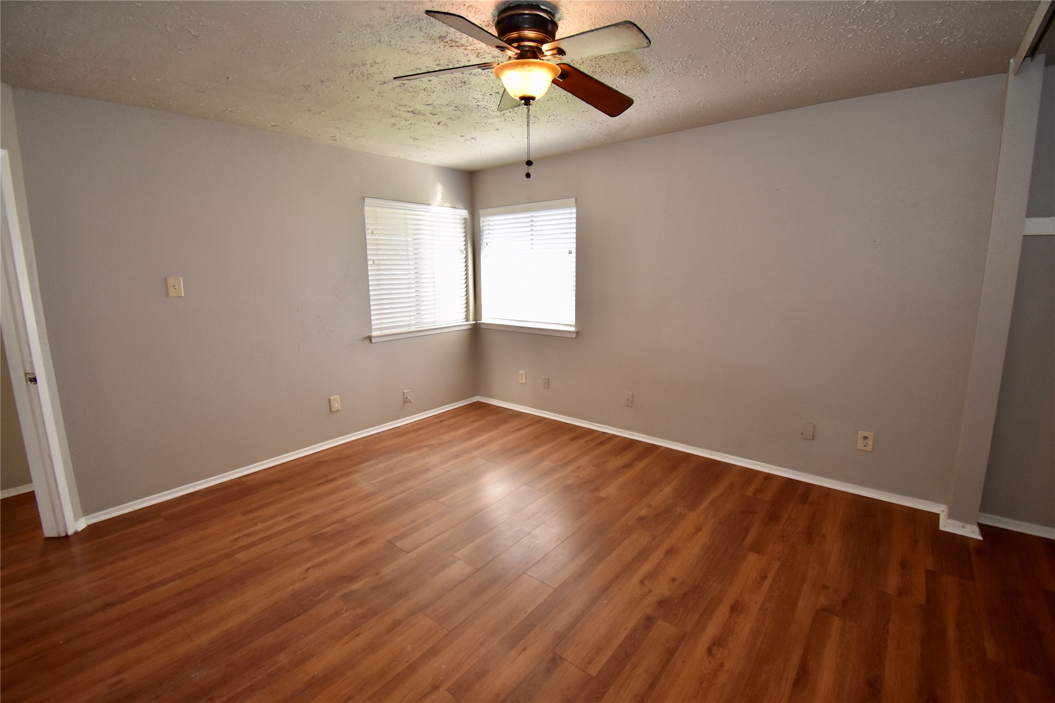 9231 Goodmeadow Drive Houston, TX 77064 - Photo 17 of 26 wooden floor in an empty room with a window