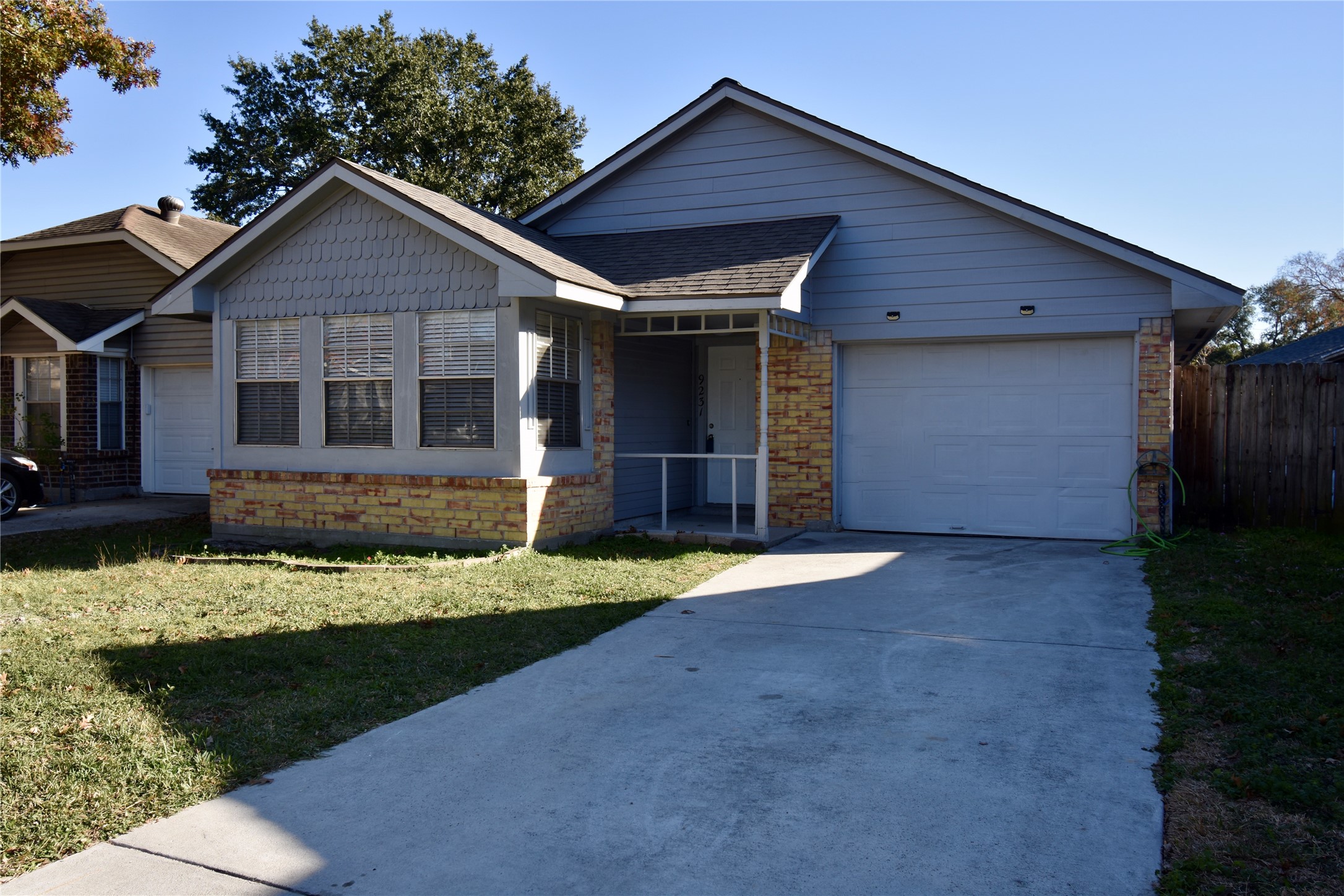 9231 Goodmeadow Drive Houston, TX 77064 - Photo 2 of 26 a front view of a house with a yard and garage