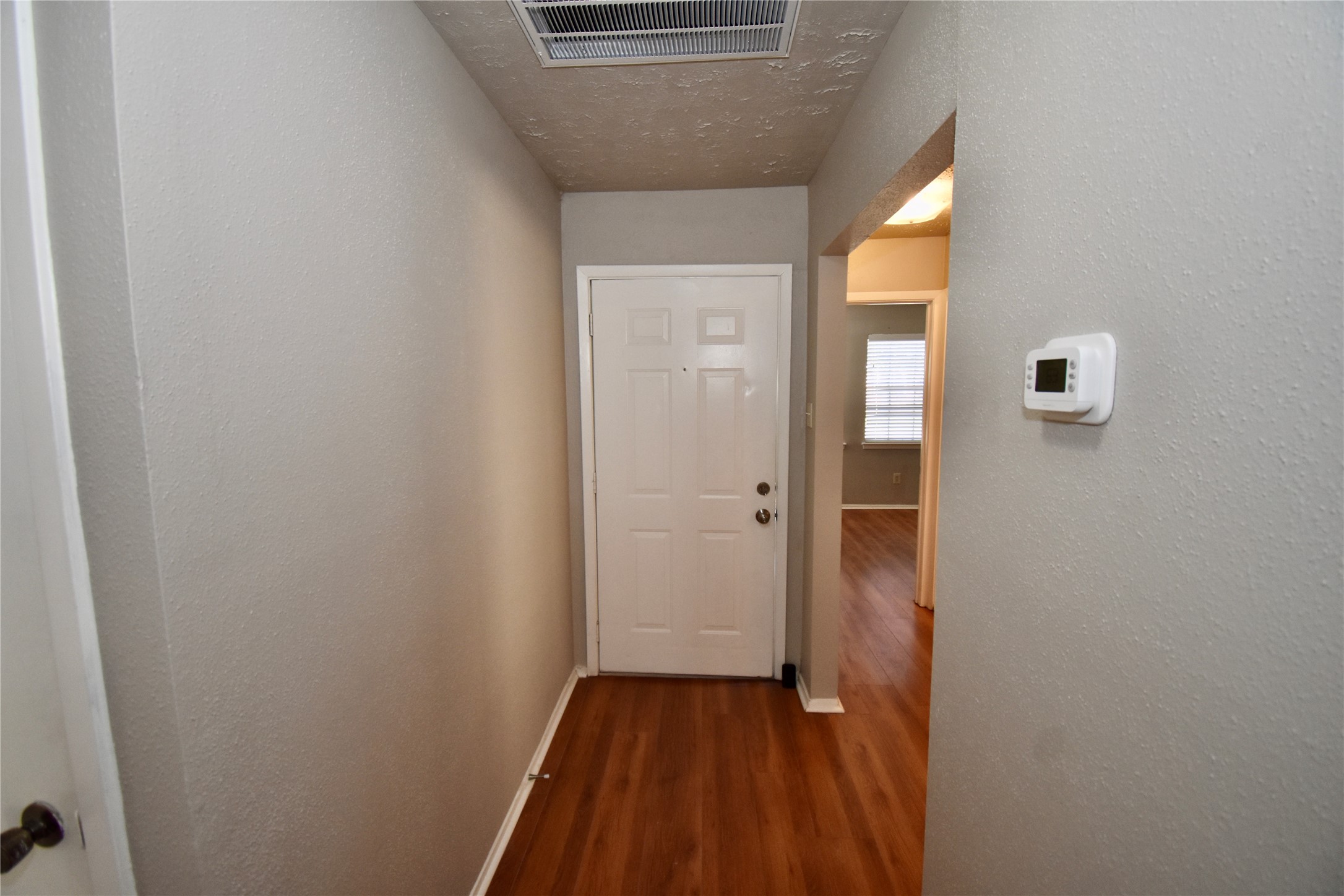 9231 Goodmeadow Drive Houston, TX 77064 - Photo 4 of 26 a view of a hallway with wooden floor and closet