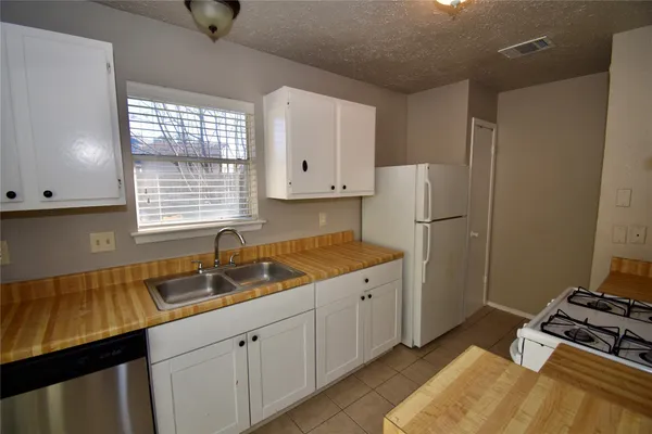 a kitchen with a sink stove and refrigerator