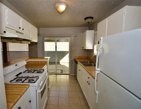 a kitchen with a stove and a refrigerator