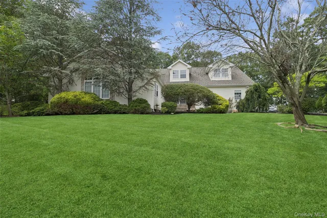 a front view of house with yard and green space
