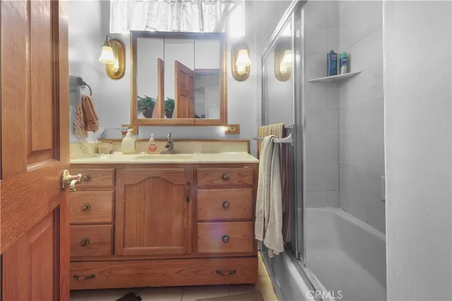 a bathroom with a sink vanity and a mirror