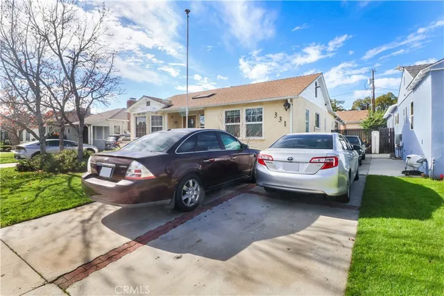 a view of a car parked in front of a brick house